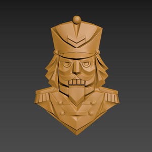 May include: A tan-colored bust of a nutcracker soldier, featuring a stern expression, a tall hat, and a detailed uniform with epaulettes. The design is geometric and stylized, with sharp angles and defined features.