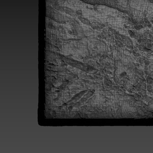 May include: A close-up of a textured, gray, rectangular surface with a black and gray stylus lying on top.