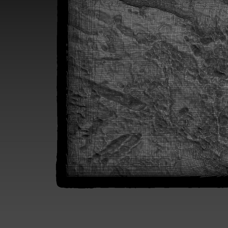 May include: A close-up of a textured, gray, rectangular surface with a black and gray stylus lying on top.