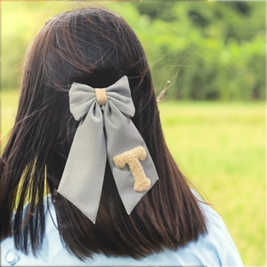 Handmade, linen, punch needle embroidered hair bow personalized with initials.