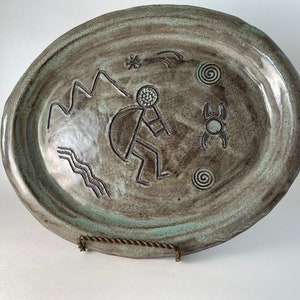 Vintage studio art pottery platter signed by artist, glazed stoneware bowl greens browns grays, decorated with primitive dancing man design