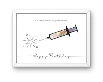 Puede incluir: Una tarjeta blanca enmarcada con una ilustración en blanco y negro de una jeringa llena de dinero. El texto en la tarjeta dice "Ein kleiner Piekser für große Träume! Happy Birthday".