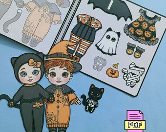 May include: A digital download for Halloween costumes, featuring paper dolls and outfits. The image displays two paper dolls in cat and witch costumes, plus costume pieces such as a ghost, pumpkin, and bat. Text includes "Happy Halloween Costume" and "PDF Digital Download".