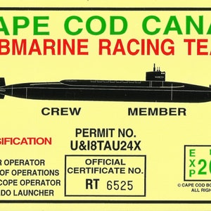 May include: A yellow novelty certificate for the Cape Cod Canal Submarine Racing Team. The certificate features a black submarine illustration, text including "Crew Member," and a permit number. It also includes a 2004 expiration date.