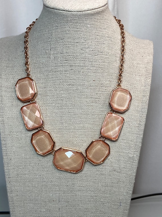 Light peach coloured acrylic cabochon necklace on 