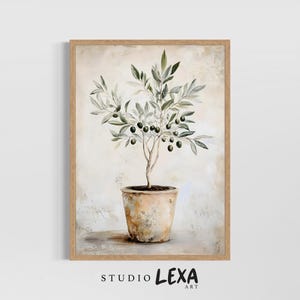 May include: A framed art print depicting an olive tree in a terracotta pot. The painting uses a neutral colour palette with green leaves and black olives. The artwork is signed "STUDIO LEXA ART".