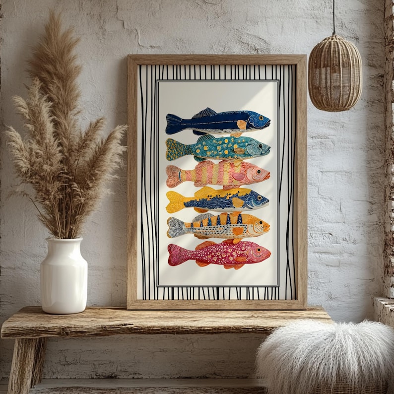 May include: A framed print displaying seven illustrated fish in various colours and patterns. The fish include shades of blue, green, yellow, and red. The artwork is set against a cream background with a black and white striped border.