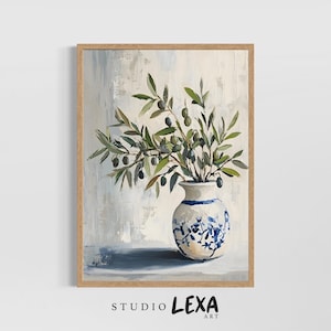 May include: A framed painting depicting a white vase with blue floral patterns, holding olive branches with green olives. The artwork features a neutral background with visible brushstrokes. The frame is light brown. The text "STUDIO LEXA ART" is at the bottom.