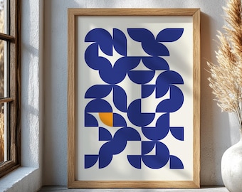 May include: A framed art print featuring a geometric design. The artwork showcases a pattern of blue semi-circles and squares against a cream background, with a single orange square. The frame is made of light brown wood.