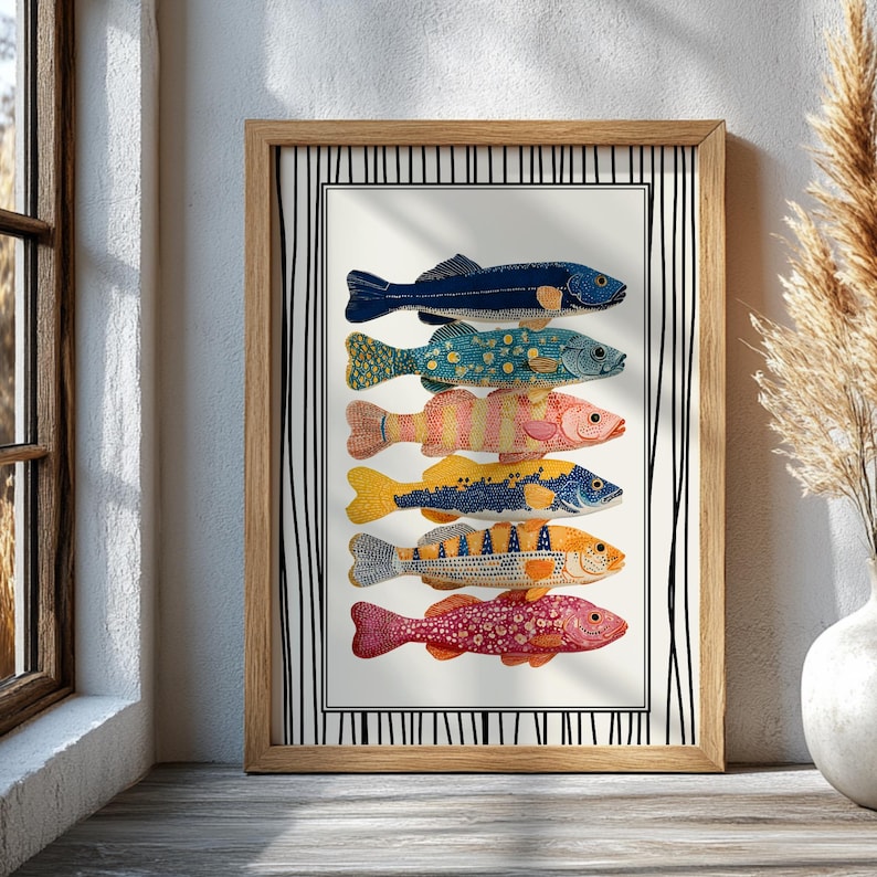 May include: A framed art print showcasing six vibrantly coloured fish illustrations. Each fish displays a unique pattern in shades of blue, yellow, orange, and pink. The artwork is set against a white background with a black and white striped border, within a wooden frame.
