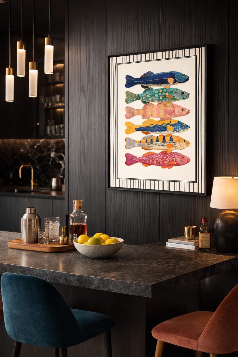 May include: A framed print displaying six vibrantly coloured fish illustrations. The fish are in shades of blue, green, pink, yellow, and orange. The artwork is set in a contemporary kitchen with dark wood panelling.