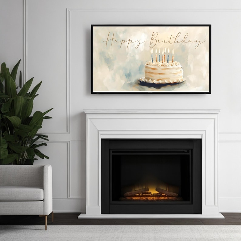 May include: A framed art print featuring a birthday cake with lit candles. The words "Happy Birthday" are written in cursive above the cake. The artwork is displayed above a white fireplace.