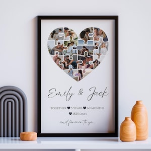 May include: A framed heart-shaped photo collage with a black frame. The collage is made of puzzle pieces, each displaying a different photo. Text at the bottom reads "Emily & Jack" and "Together 5 Years 60 Months 1825 Days and forever to go..."