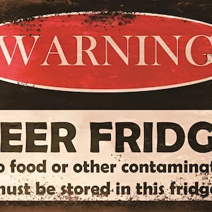 May include: A red and white warning sign with the text "WARNING" in a red oval and the text "BEER FRIDGE" in black with the text "No food or other contaminates must be stored in this fridge."