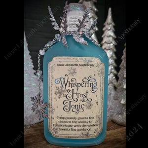 May include: A blue glass bottle with a silver snowflake charm and a label that reads "Whispering Frost Tonic". The label also says "Temporarily grants the drinker the ability to communicate with the winter spirits for guidance."