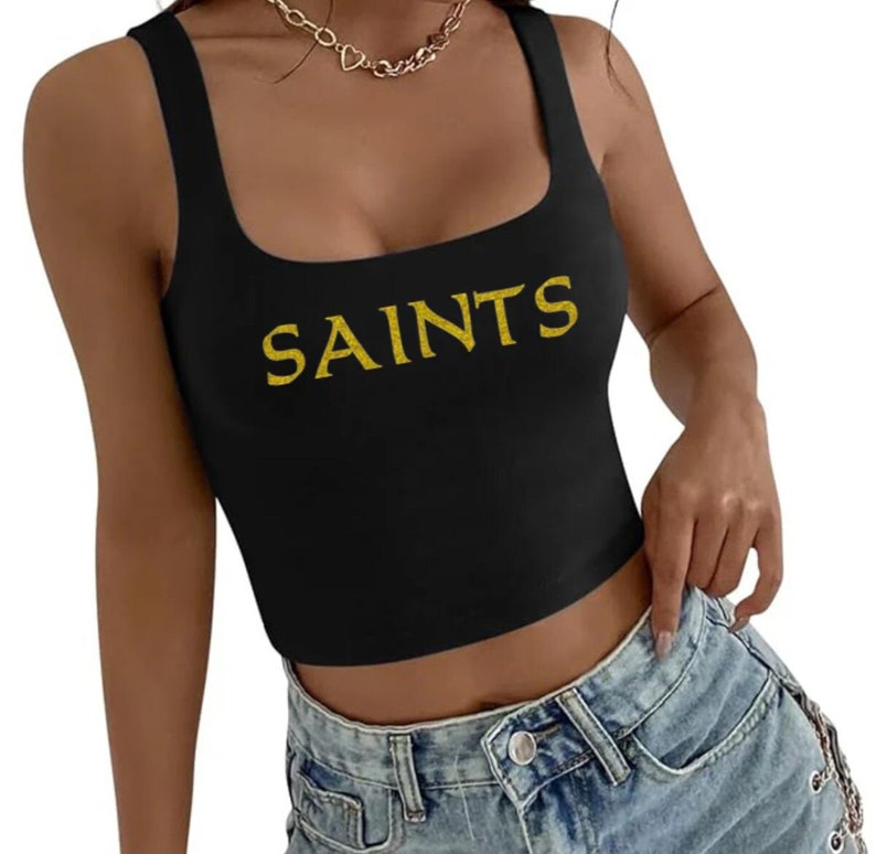 May include: A black crop top with a gold "SAINTS" graphic.