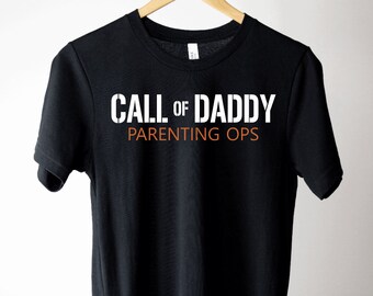 May include: Black t-shirt with white text that reads "Call of Daddy Parenting Ops".