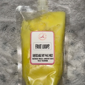 May include: A yellow squeeze pouch of soy wax melt labeled "Fruit Loops" with the instructions "SQUEEZABLE SOY WAX MELT SQUEEZE SMALL AMOUNT INTO WAX WARMER".