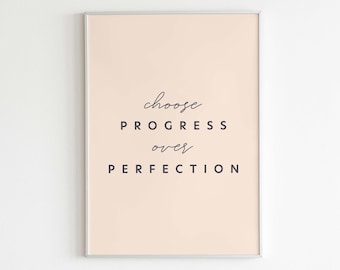 May include: A framed print with a peach background and the text "choose progress over perfection" in black. The print is framed in a silver frame and has the text "Letters to Future Self" in black at the bottom.