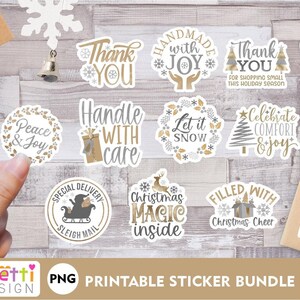 May include: A set of 12 printable Christmas stickers featuring various festive themes, including "Peace & Joy", "Handmade with Joy", "Let it Snow", "Christmas Magic Inside", and "Holly Jolly Delivery". The stickers are designed in a white and gold colour scheme with a rustic, vintage aesthetic.
