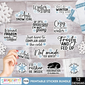 May include: A collection of winter-themed stickers with various phrases like "Winter is Stupid" and "I'd Rather Be Inside." The stickers feature snowflakes and humorous sayings in black and blue. A pair of white and blue mittens and decorative snowflakes are also visible.