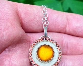 amber encircled with garnets in sterling silver