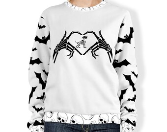 May include: White sweatshirt with a black skeleton hand heart design and a skeleton dog inside the heart. The sleeves have a black bat pattern. The bottom of the sweatshirt has a black skull pattern.
