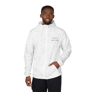 May include: A white hooded jacket with a zipper closure and a pocket. The jacket has the text "Print it your way" printed on the chest. The person is wearing black pants.