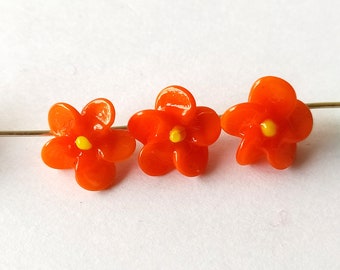 3 antique orange glass beads in the shape of flowers