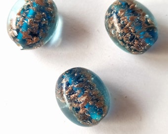 3 blue-petrol colored handmade glass beads