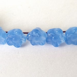 10 light blue glass beads in the shape of flowers image 2