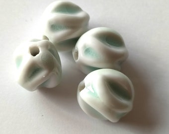 4 oval porcelain beads, irregularly shaped, white with light mint