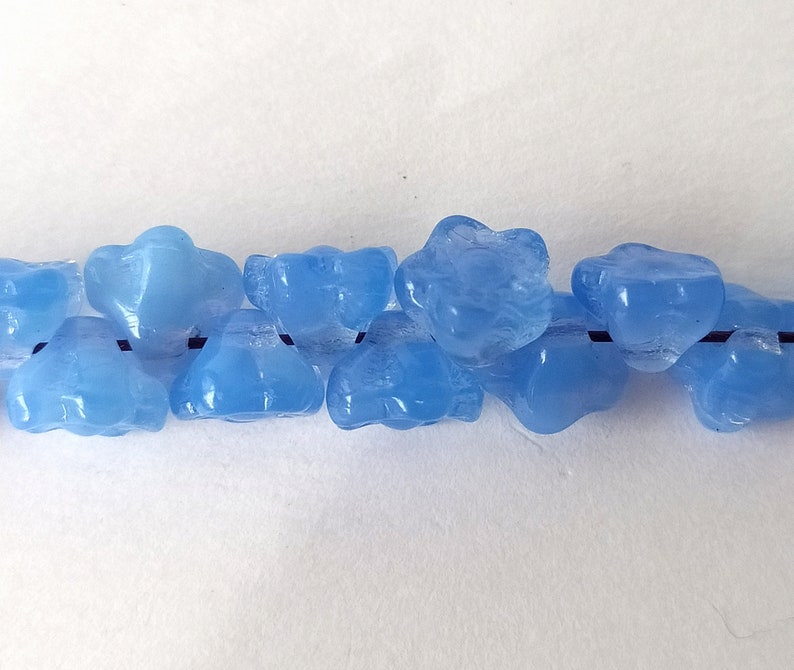 10 light blue glass beads in the shape of flowers image 5