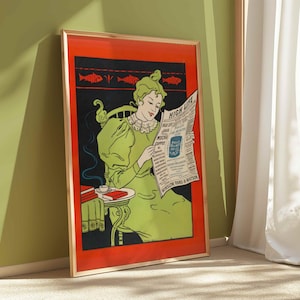 Könnte beinhalten: Gerahmte Vintage-Werbung mit einer Frau in einem grünen Kleid, die eine Zeitung mit dem Titel "High Life" liest. Das Kunstwerk hat einen roten Rand und einen goldenen Rahmen. Ein kleiner Tisch mit Tasse und Untertasse befindet sich neben der Frau.