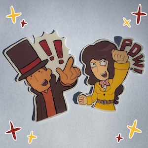 May include: Two cartoon stickers featuring characters from a video game. One character wears a top hat and points, the other in a yellow suit with a "POW!" speech bubble. The stickers have a white border and are decorated with star accents.
