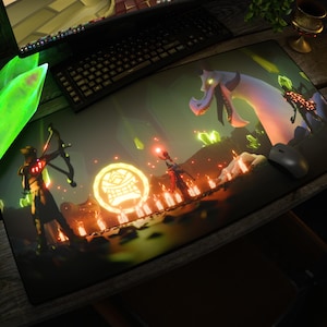 May include: A rectangular desk mat featuring a dark fantasy illustration of a large white dragon, a glowing circular emblem, and two figures, one holding a bow and the other a staff, set against a backdrop of glowing green crystals and orange light.