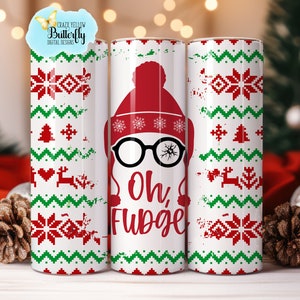 May include: White tumbler with a festive Christmas sweater design. The design includes red and green pixelated patterns, a red hat, black glasses with a cracked lens, and the words "Oh, FUDGE" in red. The tumbler has a capacity of 20 ounces.