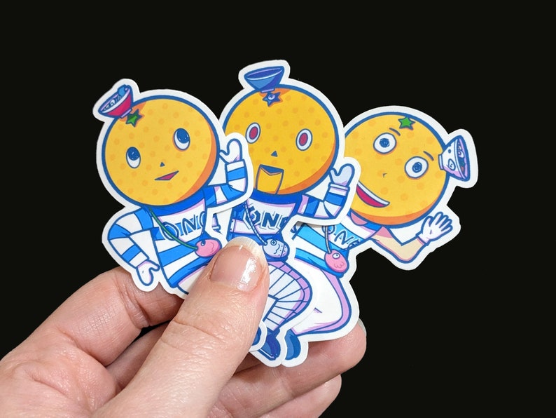 May include: Three cartoon orange stickers with blue and white striped shirts and hats. Each sticker has a different facial expression and a different design on their shirt.