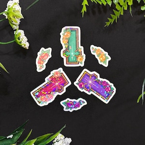 May include: Five holographic stickers featuring crosses with floral designs. The crosses are in shades of green, purple, and pink. The flowers are in shades of yellow, pink, and orange.
