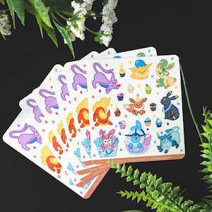 May include: A set of colourful stickers featuring various Pokemon characters, including Pikachu, Eevee, and Charmander. The stickers are designed with a birthday theme and include images of cupcakes, balloons, and party hats.