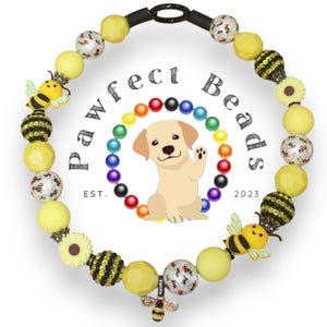 May include: A yellow beaded dog collar with bee and flower details. The collar includes various yellow beads, bee charms, and a central logo with a dog illustration and the text "Pawfect Beads EST. 2023".