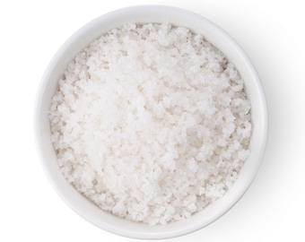 May include: A white ceramic bowl filled with white sea salt.