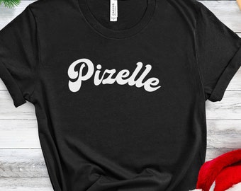 May include: Black t-shirt with white text that says "Pizelle" in a retro font.