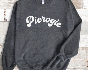 May include: A dark gray sweatshirt with the word "Pierogie" printed in white in a retro font.