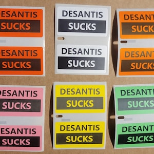 DeSantis Sucks Stickers - 1.25 x 2.25 inches - Choice of Colors, Political Decals, Ron DeSantis