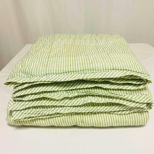 Detailed view of hand-stitched kantha quilting, showing green stripe pattern, durable construction, and artisanal Indian craftsmanship for authentic boho and farmhouse style bedding. Full bedspread view of reversible green stripe Kantha quilt, made from 100% cotton, lightweight, breathable, and ideal as coverlet or throw, perfect for home, wedding, or gift use.