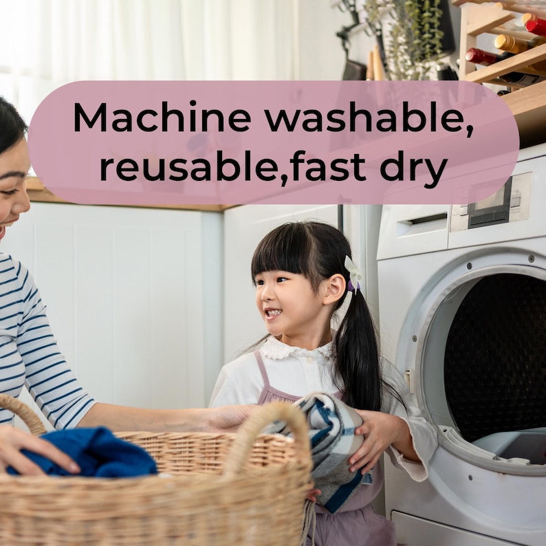 May include: A woman and a young girl are in a laundry room. The girl holds a folded blanket near a washing machine. A basket of laundry is in the foreground. Text on a pink banner reads: Machine washable, reusable, fast dry.