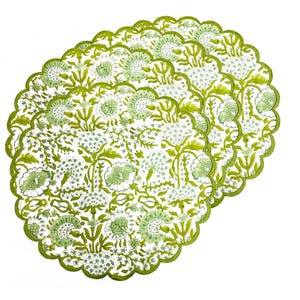 May include: Four scalloped placemats with a floral design. The placemats have a white base, adorned with a repeating pattern of green flowers and foliage. A darker green scalloped border trims the edges of each placemat.