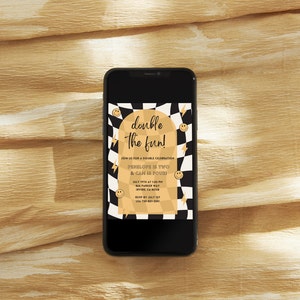 May include: A digital invitation on a smartphone screen with a black and white chequered background and gold accents. The text reads "double the fun!" and includes details for a birthday party for Penelope and Cam.