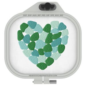 May include: An embroidery hoop with a heart design. The heart is composed of green and teal-colored pebble-like shapes. The text on the hoop reads ".DST.EXP .HUS .JEF .PES .VIP .VP3 .XXX .100" and "HEARTSTITCHESCRAFTS.ETSY.COM".